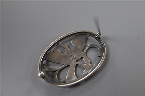 A post 1945 Georg Jensen 925 pierced oval brooch, decorated with a bird in flight, design no. 238, 43mm, 10 grams.